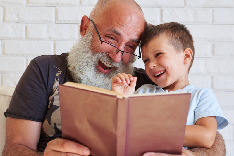 Grandfather reading to his grandson