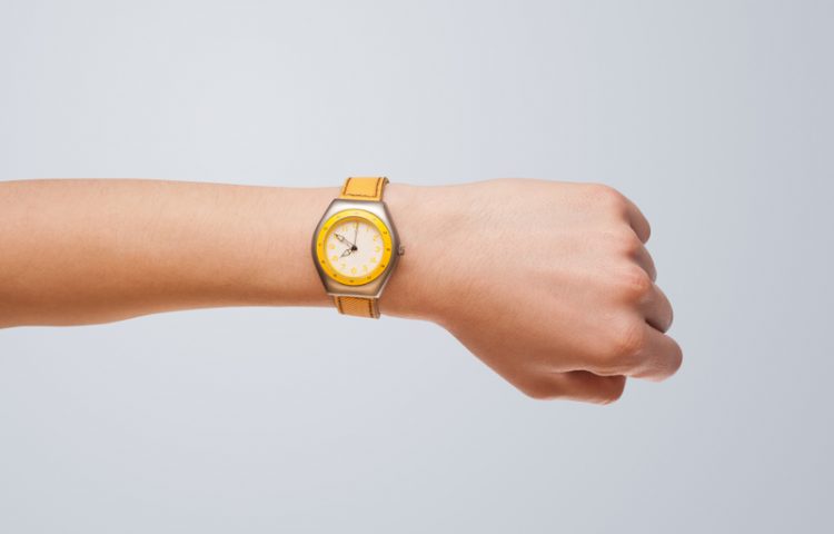 Hand with modern watch showing precise time