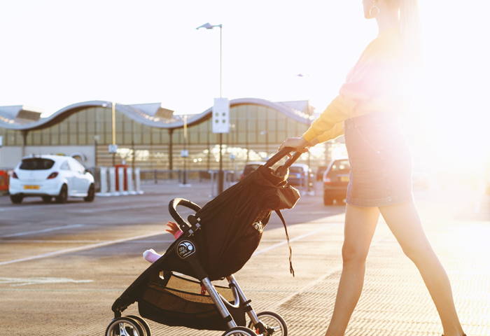 mother walking child in stroller