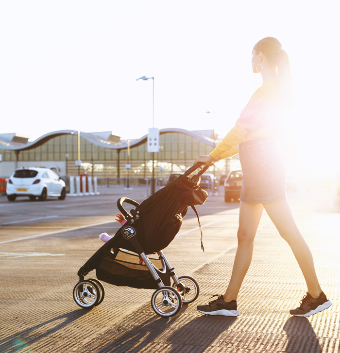 mother walking child in stroller